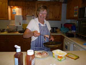 Jenny cooking bacon butties